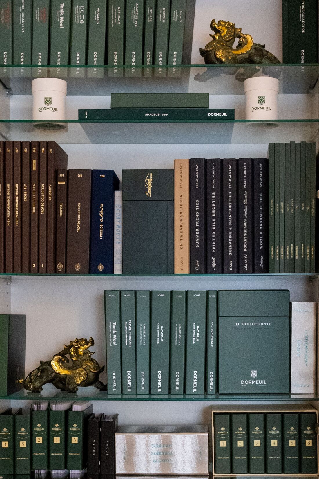 well-organized bookshelf stacked with textiles & fabric